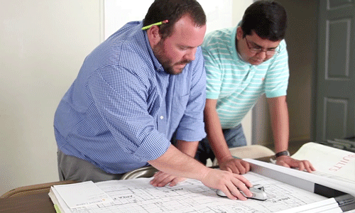 two people discussing a blueprint